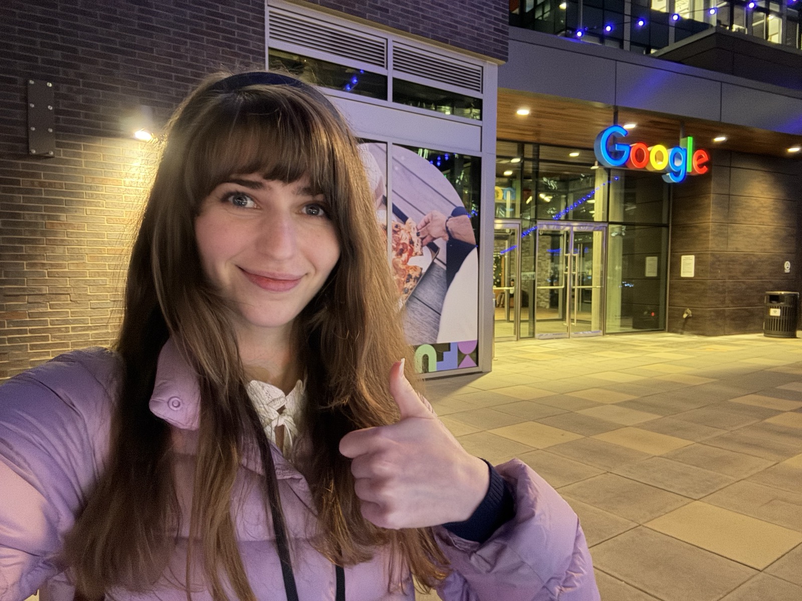 Laurie Wired giving a thumbs-up outside a Google building